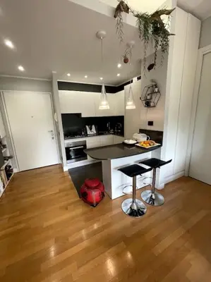 a kitchen with a table and two stools in a room at VaticanoDreamSuite in Rome