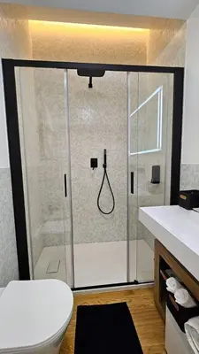 a bathroom with a shower with a toilet and a sink at Val's Vatican Wall Apartment in Rome