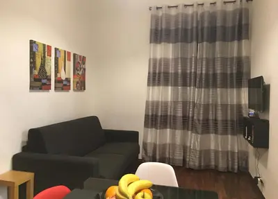 a living room with a couch and a table with bananas at Residenza San Martino in Rome