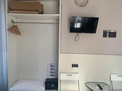 a room with a bed and a tv on a wall at Residenza Cernaia in Rome