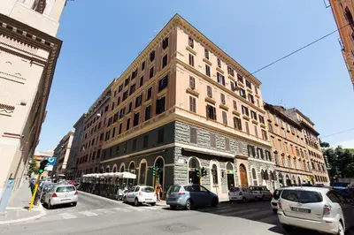 a tall building on a city street with parked cars at Residenza Cernaia in Rome