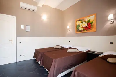 a room with two beds and a painting on the wall at Residenza Cernaia in Rome
