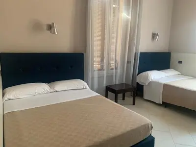 a bedroom with two beds and a window at Residenza Cernaia in Rome