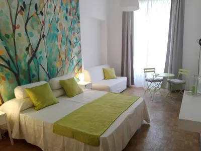 a bedroom with a large bed with a painting on the wall at Domus Crescenzio - Guest House in Rome