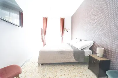 a bedroom with a bed and a window at Trastevere Lovely 2 BR Apartment in Rome
