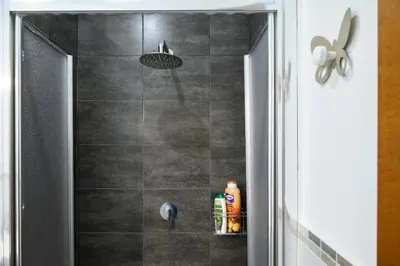 a bathroom with a shower with a shower head at vatican house in Rome
