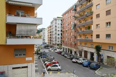 a city street with parked cars and buildings at vatican house in Rome