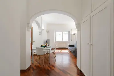 an archway in a living room with a table and chairs at vatican house in Rome