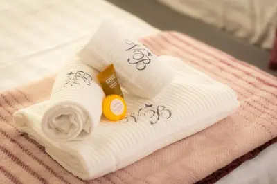 a towel with a roll of toilet paper on a bed at Frattina Atmosphere by Rental in Rome in Rome
