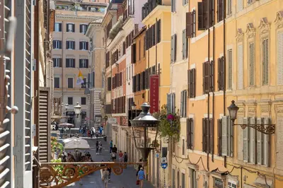 a street in the city with people walking down the street at Frattina Atmosphere by Rental in Rome in Rome