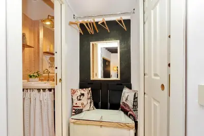 a small bathroom with a chair and a mirror at 3Chic Maison Colosseo in Rome