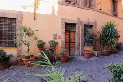 a bunch of potted plants on the side of a building at 3Chic Maison Colosseo in Rome