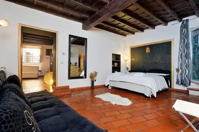 a living room with a bed and a couch at 3Chic Maison Colosseo in Rome