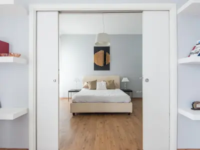 a bedroom with a bed and a glass door at Auditorium Luxury Apartments in Rome
