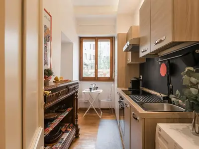 a kitchen with a sink and a stove top oven at The Best Rent – Charming flat near Colosseo in Rome