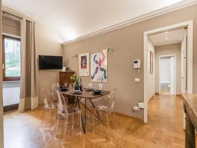 a dining room with a table and chairs at The Best Rent – Charming flat near Colosseo in Rome