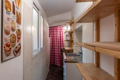 a small kitchen with a counter and a sink at GuestHost - Fori Imperiali Pretty Apartment in Rome