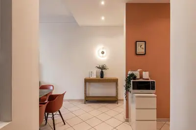 a hallway with white walls and a dining room at The Best Rent – Bright three-bedroom apartment along the Tiber River in Rome