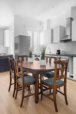 a kitchen with a wooden table and four chairs at Sunny House Gianicolo in Rome