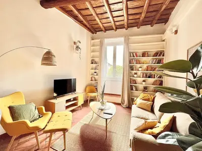 a living room with a couch and a tv at Oasi di relax a Trastevere in Rome