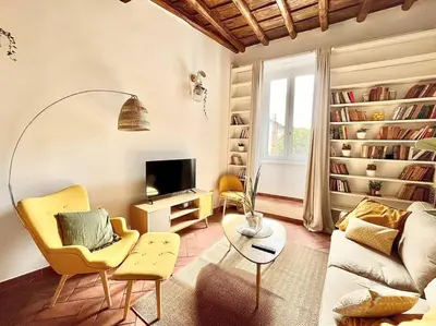 a living room with a couch and chairs and a tv at Oasi di relax a Trastevere in Rome