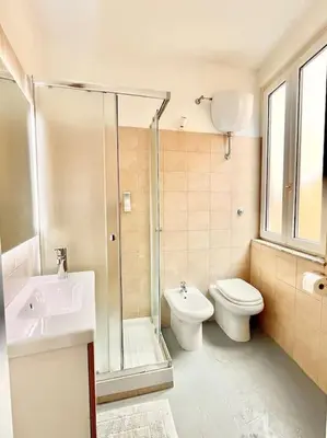 a bathroom with a shower and a toilet and a sink at Oasi di relax a Trastevere in Rome