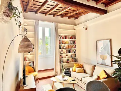 a living room with a couch and a book shelf at Oasi di relax a Trastevere in Rome