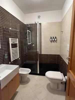 a bathroom with a toilet and a sink and a shower at Miro Home II in Rome