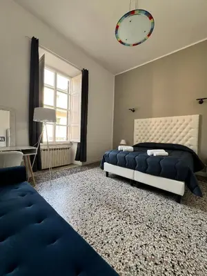 a bedroom with two beds and a clock on the wall at Luxury room Anelli center of Roma in Rome