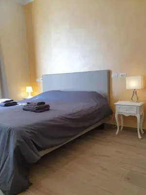 a bedroom with a bed and a table with a lamp at Lombardo in Rome