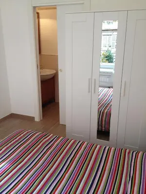 a bedroom with a bed and a bathroom with a window at Lombardo in Rome