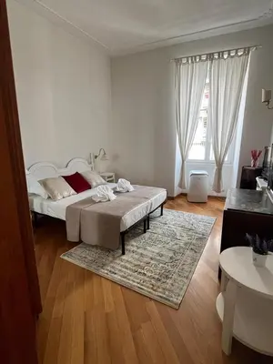 a white bedroom with a bed and a rug at SAN PIETRO VATICAN AREA LARGE APARTMENT - near SUBWAY in Rome