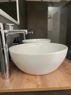a bathroom with a white sink and a faucet at Lucilla’s Suite San Pietro station in Rome