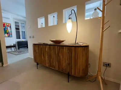 a lamp on top of a wooden cabinet in a room at CARPE DIEM Ponte Milvio Olimpico Farnesina in Rome