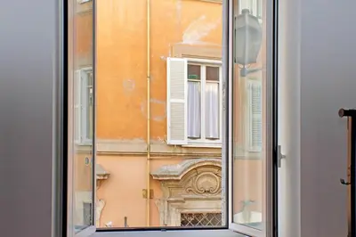 a view of a building through a window at 4BNB - Lungaretta Jacuzzi Apartment in Rome
