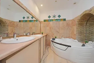 a bathroom with a tub and a sink at 4BNB - Lungaretta Jacuzzi Apartment in Rome