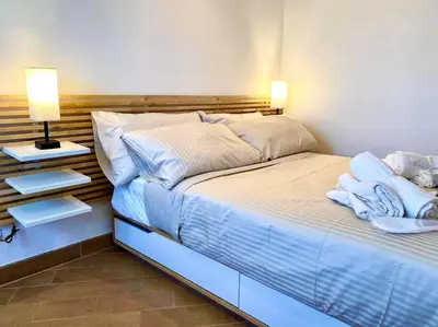 a bedroom with a large bed with towels on it at Al Mamalo Rome Luxury Apartment in Rome