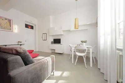 a living room with a couch and a red wall at 4BNB - Testaccio Apartment in Rome