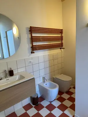 a bathroom with a sink and a toilet and a mirror at Santamaura Vatican Apartment in Rome