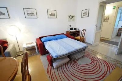 a room with a bed and a living room with a table at Casa Anna a Roma in Rome
