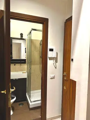a bathroom with a shower and a glass door at Rome Apartment Marconi in Rome