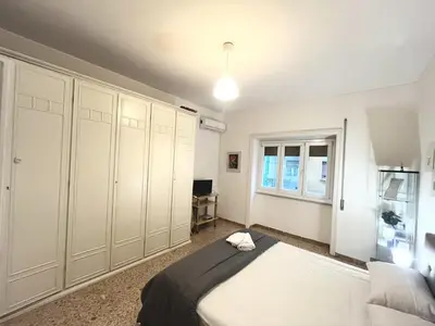 a bedroom with a bed and a window at Cuore di Marconi Apartment in Rome