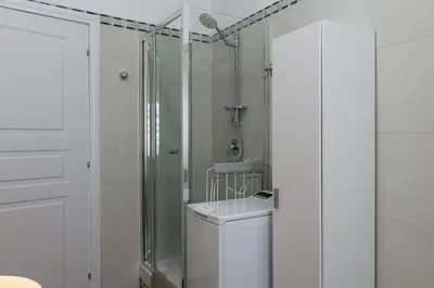 a white bathroom with a shower and a toilet at Belle Arti home in Rome