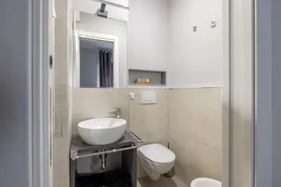 a bathroom with a sink and a toilet at Belli Suites Vatican Rome Guest House in Rome