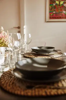 a table with black plates and glasses on it at Monteverde Suite Apartment in Rome