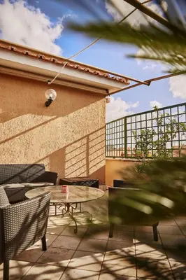 a patio with a table and chairs and a building at Monteverde Suite Apartment in Rome