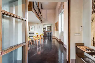 a hallway with a dining room and a kitchen at Iconic apartment with unique Colosseum view in Rome