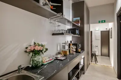 a kitchen with a sink and a vase of flowers at Joyful 148 Luxury Guest House in Rome