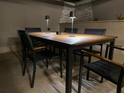 a wooden table with chairs and a lamp on top at Domus Carola in Rome