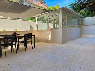 a patio with a table and chairs next to a building at Domus Carola in Rome